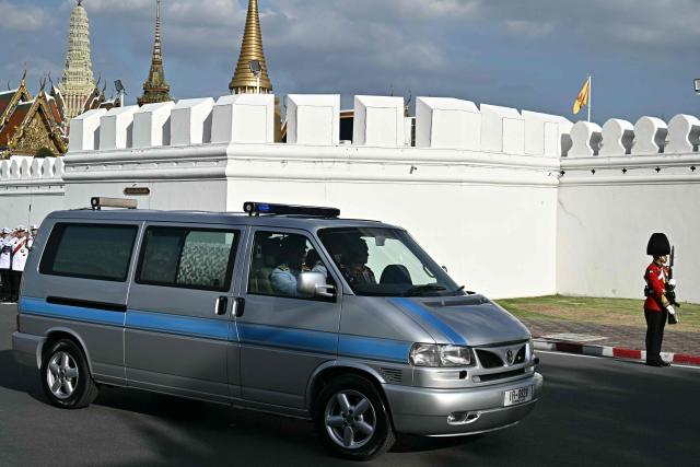 A hearse arrives at the Grand Palace carrying the body of Thai Princess Bajrakitiyabha Mahidol as mourners line the motorcade route, where funeral rites will begin for the late princess, in Bangkok on June 13, 2026. Hundreds of black-clad Thai mourners gathered at the royal palace in Bangkok on June 13, awaiting the arrival of the body of the king's eldest daughter a day after her death was announced. (Photo by Lillian SUWANRUMPHA / AFP)