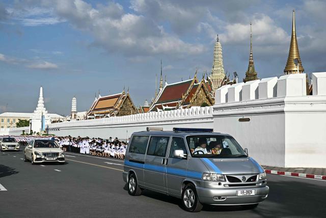 A hearse arrives at the Grand Palace carrying the body of Thai Princess Bajrakitiyabha Mahidol as mourners line the motorcade route, where funeral rites will begin for the late princess, in Bangkok on June 13, 2026. Hundreds of black-clad Thai mourners gathered at the royal palace in Bangkok on June 13, awaiting the arrival of the body of the king's eldest daughter a day after her death was announced. (Photo by Lillian SUWANRUMPHA / AFP)