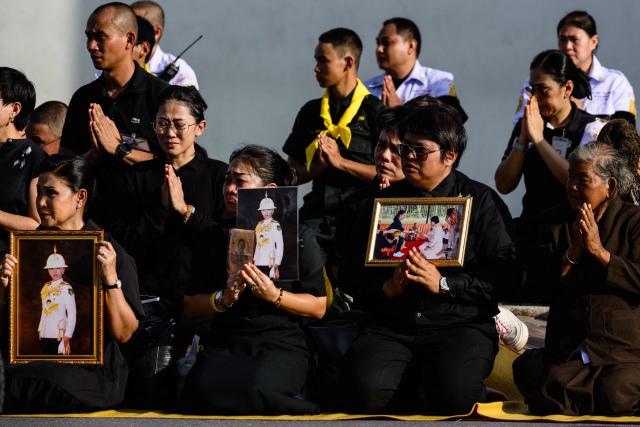 Mourners react as the hearse carrying the body of Thai Princess Bajrakitiyabha Mahidol approaches the Grand Palace, where funeral rites will begin for the late princess, in Bangkok on June 13, 2026. Hundreds of black-clad Thai mourners gathered at the royal palace in Bangkok on June 13, awaiting the arrival of the body of the king's eldest daughter a day after her death was announced. (Photo by ANTHONY WALLACE / AFP)