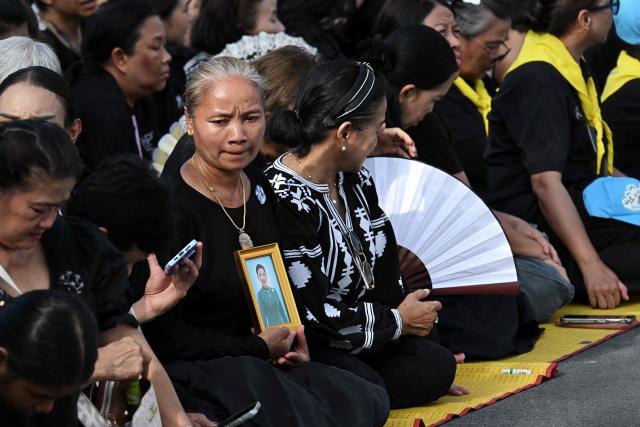 Mourners wait for the hearse to arrive carrying the body of Thai Princess Bajrakitiyabha Mahidol, in front of the Grand Palace where funeral rites will begin for the late princess, in Bangkok on June 13, 2026. Hundreds of black-clad Thai mourners gathered at the royal palace in Bangkok on June 13, awaiting the arrival of the body of the king's eldest daughter a day after her death was announced. (Photo by Lillian SUWANRUMPHA / AFP)