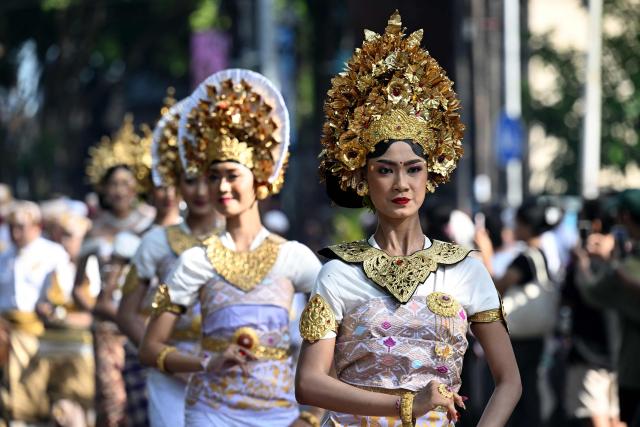 Balinese people take part in a parade during the Bali Art Festival in Denpasar, Indonesia resort island of Bali island on June 13, 2026. (Photo by SONNY TUMBELAKA / AFP)