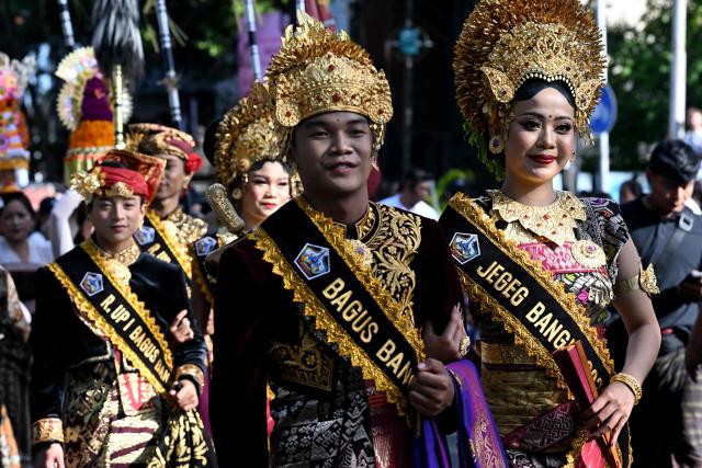 Balinese people take part in a parade during the Bali Art Festival in Denpasar, Indonesia resort island of Bali island on June 13, 2026. (Photo by SONNY TUMBELAKA / AFP)
