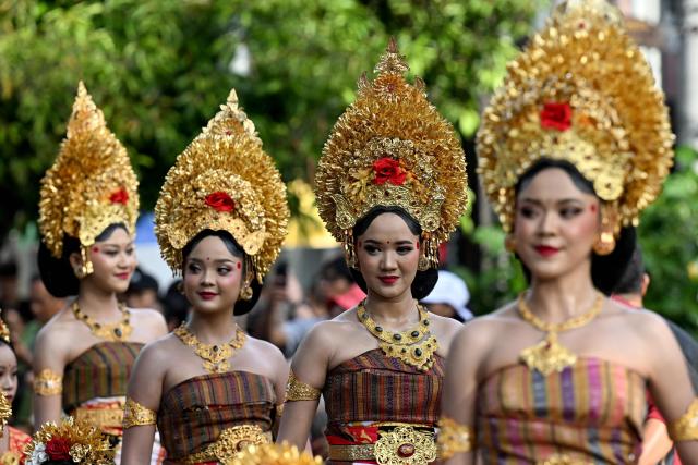 Balinese people take part in a parade during the Bali Art Festival in Denpasar, Indonesia resort island of Bali island on June 13, 2026. (Photo by SONNY TUMBELAKA / AFP)