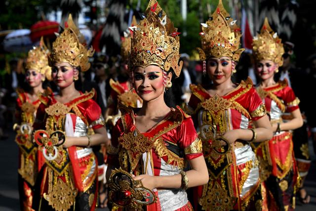 Balinese people take part in a parade during the Bali Art Festival in Denpasar, Indonesia resort island of Bali island on June 13, 2026. (Photo by SONNY TUMBELAKA / AFP)