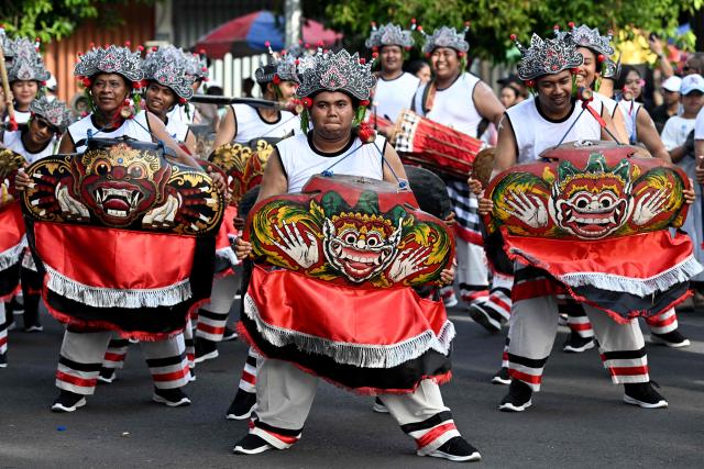 Balinese people take part in a parade during the Bali Art Festival in Denpasar, Indonesia resort island of Bali island on June 13, 2026. (Photo by SONNY TUMBELAKA / AFP)