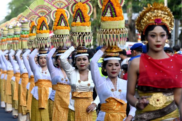 Balinese people take part in a parade during the Bali Art Festival in Denpasar, Indonesia resort island of Bali island on June 13, 2026. (Photo by SONNY TUMBELAKA / AFP)