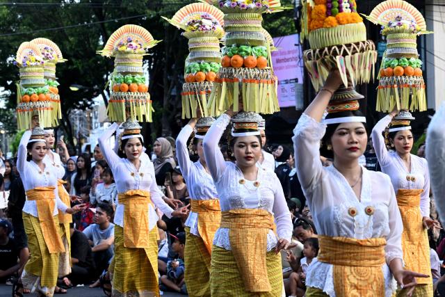 Balinese people take part in a parade during the Bali Art Festival in Denpasar, Indonesia resort island of Bali island on June 13, 2026. (Photo by SONNY TUMBELAKA / AFP)