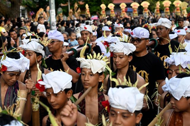Balinese people take part in a parade during the Bali Art Festival in Denpasar, Indonesia resort island of Bali island on June 13, 2026. (Photo by SONNY TUMBELAKA / AFP)
