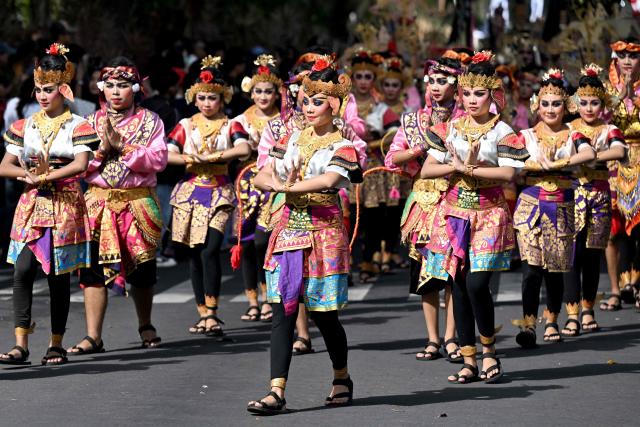 Balinese people take part in a parade during the Bali Art Festival in Denpasar, Indonesia resort island of Bali island on June 13, 2026. (Photo by SONNY TUMBELAKA / AFP)