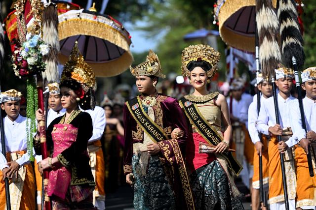 Balinese people take part in a parade during the Bali Art Festival in Denpasar, Indonesia resort island of Bali island on June 13, 2026. (Photo by SONNY TUMBELAKA / AFP)