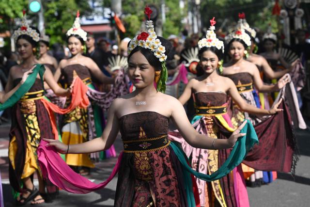 Balinese people take part in a parade during the Bali Art Festival in Denpasar, Indonesia resort island of Bali island on June 13, 2026. (Photo by SONNY TUMBELAKA / AFP)