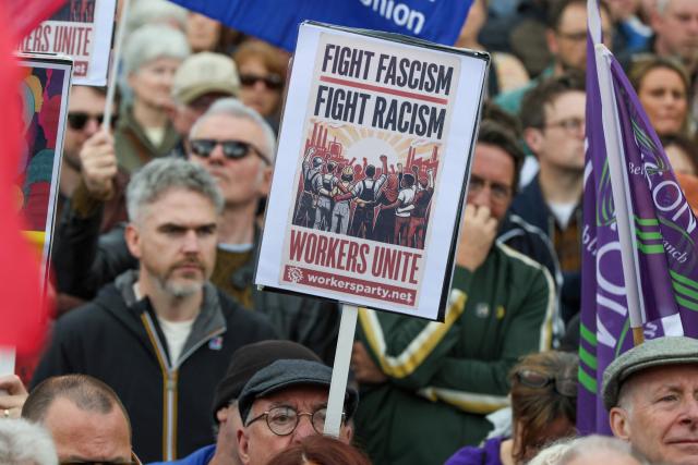 People turn out for a demonstration against racism and call for calm in central Belfast, Northern Ireland on June 13, 2026, after a few nights of disorder hit the city when video of a knife attack on June 8 went viral across social media platforms. Thousands of people on June 13 gathered for an anti-racism rally in the Northern Irish city of Belfast after unrest sparked by a horrific stabbing. (Photo by Paul Faith / AFP)