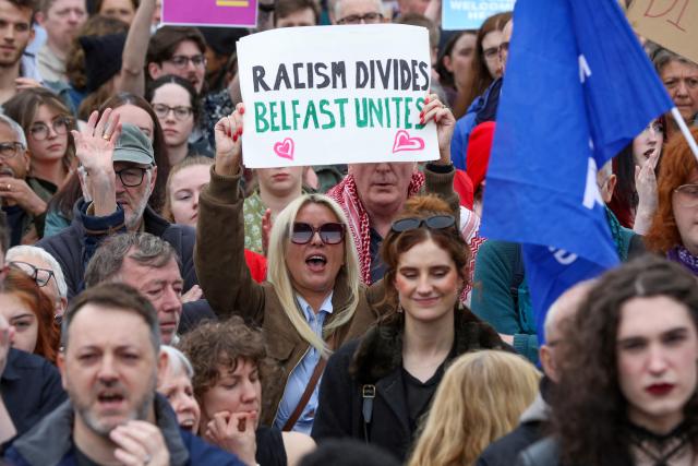 People turn out for a demonstration against racism and call for calm in central Belfast, Northern Ireland on June 13, 2026, after a few nights of disorder hit the city when video of a knife attack on June 8 went viral across social media platforms. Thousands of people on June 13 gathered for an anti-racism rally in the Northern Irish city of Belfast after unrest sparked by a horrific stabbing. (Photo by Paul Faith / AFP)
