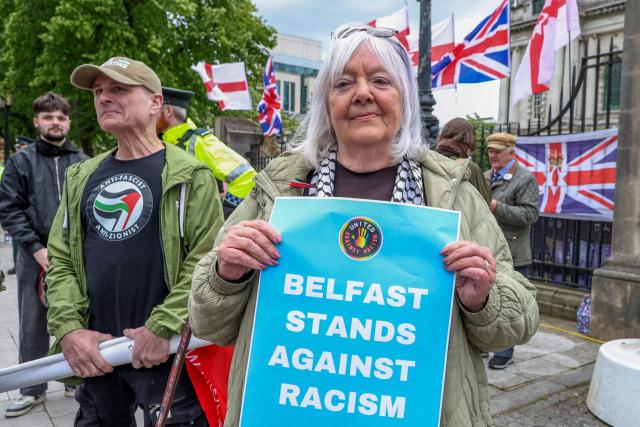 People turn out for a demonstration against racism and call for calm in central Belfast, Northern Ireland on June 13, 2026, after a few nights of disorder hit the city when video of a knife attack on June 8 went viral across social media platforms. Thousands of people on June 13 gathered for an anti-racism rally in the Northern Irish city of Belfast after unrest sparked by a horrific stabbing. (Photo by Paul Faith / AFP)