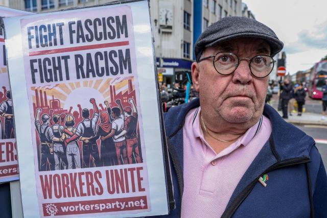 People turn out for a demonstration against racism and call for calm in central Belfast, Northern Ireland on June 13, 2026, after a few nights of disorder hit the city when video of a knife attack on June 8 went viral across social media platforms. Thousands of people on June 13 gathered for an anti-racism rally in the Northern Irish city of Belfast after unrest sparked by a horrific stabbing. (Photo by Paul Faith / AFP)