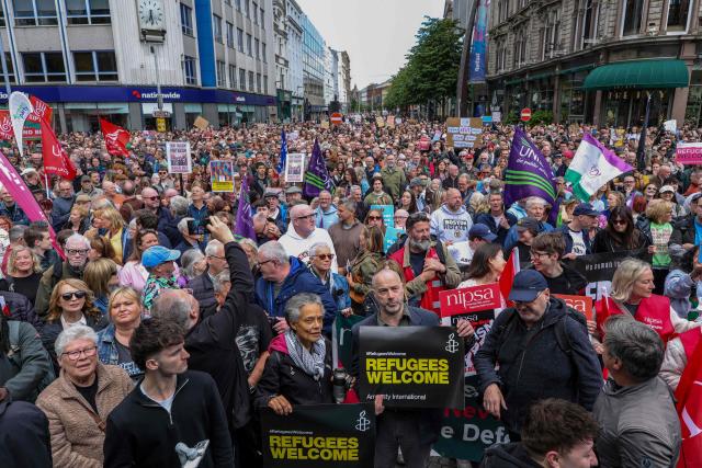 People turn out for a demonstration against racism and call for calm in central Belfast, Northern Ireland on June 13, 2026, after a few nights of disorder hit the city when video of a knife attack on June 8 went viral across social media platforms. Thousands of people on June 13 gathered for an anti-racism rally in the Northern Irish city of Belfast after unrest sparked by a horrific stabbing. (Photo by Paul Faith / AFP)