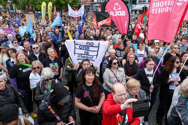 People turn out for a demonstration against racism and call for calm in central Belfast, Northern Ireland on June 13, 2026, after a few nights of disorder hit the city when video of a knife attack on June 8 went viral across social media platforms. Thousands of people on June 13 gathered for an anti-racism rally in the Northern Irish city of Belfast after unrest sparked by a horrific stabbing. (Photo by Paul Faith / AFP)