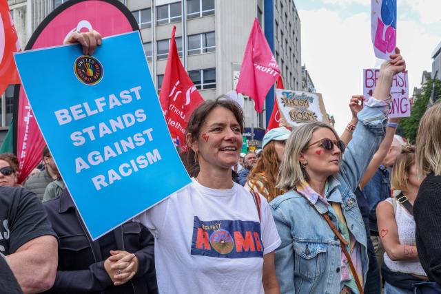People turn out for a demonstration against racism and call for calm in central Belfast, Northern Ireland on June 13, 2026, after a few nights of disorder hit the city when video of a knife attack on June 8 went viral across social media platforms. Thousands of people on June 13 gathered for an anti-racism rally in the Northern Irish city of Belfast after unrest sparked by a horrific stabbing. (Photo by Paul Faith / AFP)