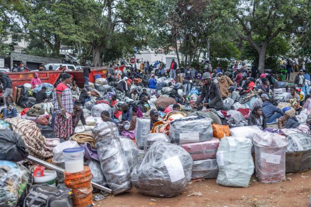 A general view of people's belongings as displaced migrants gather at Sherwood Park in Durban on June 13, 2026 after fleeing their homes amid fears of xenophobic attacks. Hundreds of migrants await repatriation to Malawi from South Africa following xenophobic violence in the country. (Photo by RAJESH JANTILAL / AFP)