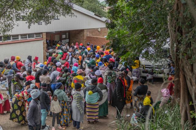 Displaced migrants wait at Sherwood Park in Durban on June 13, 2026 to be repatriated to Malawi after fleeing their homes amid fears of xenophobic attacks. Hundreds of migrants await repatriation to Malawi from South Africa following xenophobic violence in the country. (Photo by RAJESH JANTILAL / AFP)