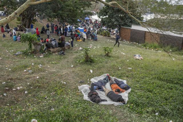 Displaced migrants wait at Sherwood Park in Durban on June 13, 2026 to be repatriated to Malawi after fleeing their homes amid fears of xenophobic attacks. Hundreds of migrants await repatriation to Malawi from South Africa following xenophobic violence in the country. (Photo by RAJESH JANTILAL / AFP)