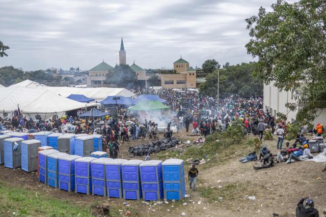 Displaced migrants wait at Sherwood Park in Durban on June 13, 2026 to be repatriated to Malawi after fleeing their homes amid fears of xenophobic attacks. Hundreds of migrants await repatriation to Malawi from South Africa following xenophobic violence in the country. (Photo by RAJESH JANTILAL / AFP)
