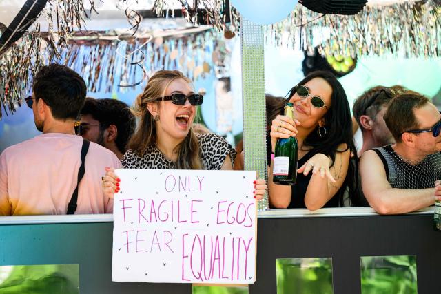 a participant holds a sign reading "Only fragile egos fear equality during the 30th edition of the Vienna Pride Parade or Rainbow Parade in Vienna on June 13, 2026. The parade is an important political demonstration advocating for the rights of lesbian, gay, bisexual, transgender, intersex and queer people, according to organisers. (Photo by MAX SLOVENCIK / APA / AFP) / Austria OUT