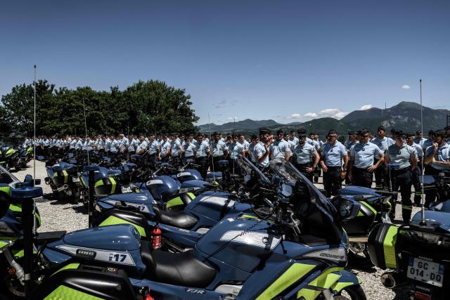 Members of the French gendarmerie motorcycling unit stand next to motocycles as they attend a general briefing for G7 security operations prior to the summit, in La Roche-sur-Foron, eastern France, on June 12, 2026. (Photo by Jeff PACHOUD / AFP)