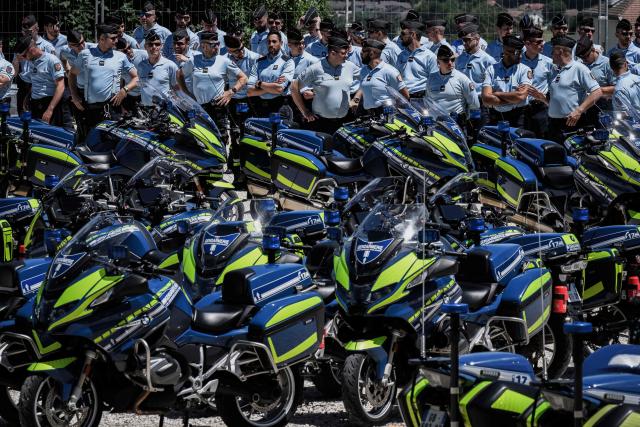 Members of the French gendarmerie motorcycling unit stand next to motocycles as they attend a general briefing for G7 security operations prior to the summit, in La Roche-sur-Foron, eastern France, on June 12, 2026. (Photo by Jeff PACHOUD / AFP)