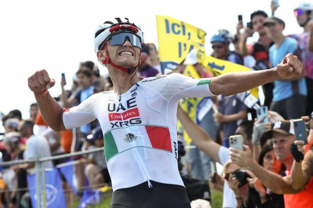 UAE Team Emirates XRG's Mexican rider Isaac Del Toro Romero celebrates as he cycles across the finish line to win the 7th stage of the Tour Auvergne-Rhone-Alpes cycling race (formerly known as the Criterium du Dauphine), 133,6km between La Bridoire and Grand Colombier in the French Alps on June 13, 2026. (Photo by Anne-Christine POUJOULAT / AFP)