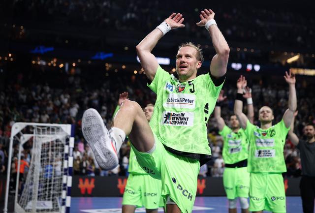 Fuechse Berlin's Swedish pivot #05 Max Darj celebrates after winning the EHF Handball Champions League Final 4 semi-final match between SC Magdeburg and Fuechse Berlin in Cologne, western Germany on June 13, 2026. (Photo by Ronny HARTMANN / AFP)