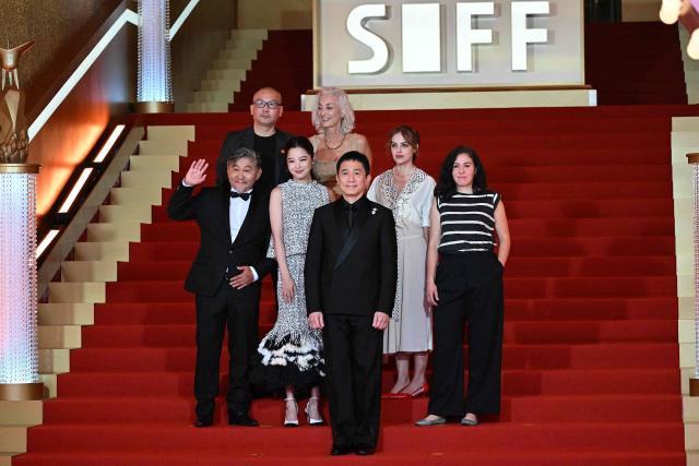 The jury of the Golden Goblet Awards including Hong Kong actor Tony Leung Chiu Wai (front) arrive on the red carpet of the 28th Shanghai International Film Festival (SIFF) in Shanghai, on June 13, 2026. (Photo by Jade Gao / AFP)