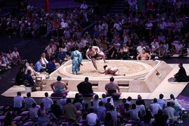 Ukranian sumo wrestler Aonishiki battles Japanese sumo wrestler Ura during their bout on day 1 of the 2026 MUFG Paris Sumo Tournament, in Paris on June 13, 2026. (Photo by Behrouz MEHRI / AFP)