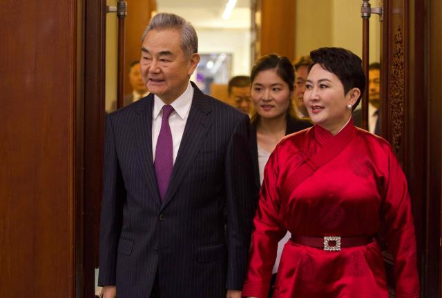 China's Minister of Foreign Affairs Wang Yi (L) walks next to Mongolia's Minister of Foreign Affairs Batmunkh Battsetseg (R) at a press conference after their bilateral meeting in Ulaanbaatar on June 13, 2026. (Photo by BYAMBASUREN BYAMBA-OCHIR / AFP)