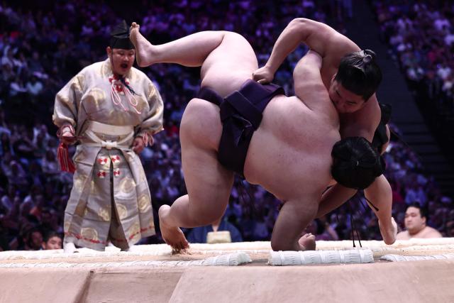Japanese sumo wrestler Oho (L) battles Japanese sumo wrestler Wakamotoharu during their bout on day 1 of the 2026 MUFG Paris Sumo Tournament, in Paris on June 13, 2026. (Photo by Behrouz MEHRI / AFP)