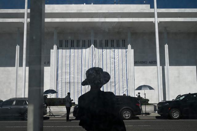 A tarp covers the facade of the John F. Kennedy Memorial Center for the Performing Arts in Washington, DC, on June 13, 2026. Workers began removing President Donald Trump's name from the facade of the John F. Kennedy Center for the Performing Arts on Saturday, after a federal judge ruled that its renaming was unlawful. The effort came after a judge rejected a last-minute bid by the center's board to halt the removal of Trump's name. (Photo by Alex WROBLEWSKI / AFP)