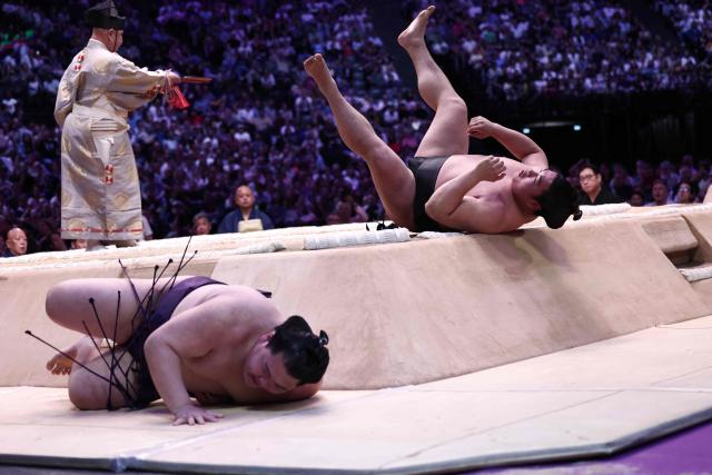 Japanese sumo wrestler Oho (L) battles Japanese sumo wrestler Wakamotoharu during their bout on day 1 of the 2026 MUFG Paris Sumo Tournament, in Paris on June 13, 2026. (Photo by Behrouz MEHRI / AFP)