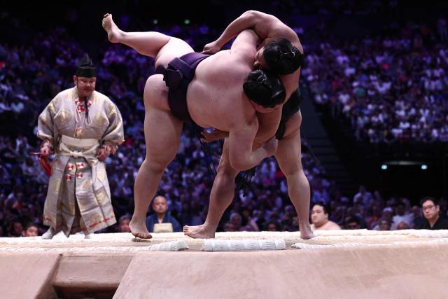 Japanese sumo wrestler Oho (L) battles Japanese sumo wrestler Wakamotoharu during their bout on day 1 of the 2026 MUFG Paris Sumo Tournament, in Paris on June 13, 2026. (Photo by Behrouz MEHRI / AFP)