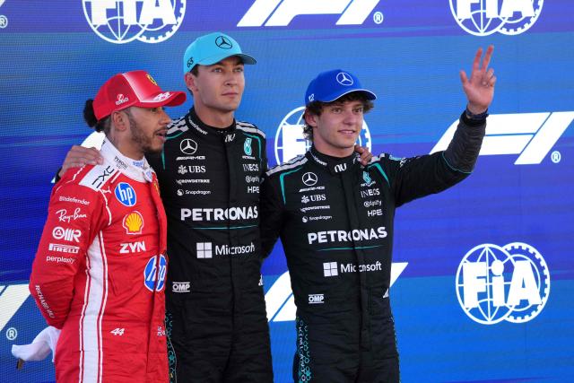 Mercedes' British driver George Russell celebrates pole position with second placed Ferrari's British driver Lewis Hamilton (L) and third placed Mercedes' Italian driver Kimi Antonelli (R) after the qualifying session at the Circuit de Catalunya ahead of the Catalonia Formula One Grand Prix in Montmelo, on the outskirts of Barcelona, on June 13, 2026. (Photo by Manaure QUINTERO / AFP)