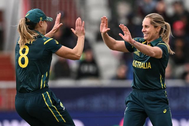 Australia's Ellyse Perry (L) and Australia's captain Sophie Molineux (R) celebrate after dismissing South Africa's Suné Luus (not pictured), during the ICC Women's T20 cricket world cup 2026 game between Australia and South Africa, at Old Trafford in Manchester, north-west England on June 13, 2026. (Photo by Oli SCARFF / AFP)