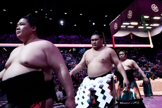 Japanese sumo wrestler Hoshoryu (C) leaves after a bout on day 1 of the 2026 MUFG Paris Sumo Tournament, in Paris on June 13, 2026. (Photo by Behrouz MEHRI / AFP)