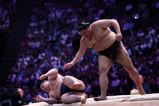Japanese sumo wrestler Wakanosho (L) battles Japanese sumo wrestler Abi during their bout on day 1 of the 2026 MUFG Paris Sumo Tournament, in Paris on June 13, 2026. (Photo by Behrouz MEHRI / AFP)