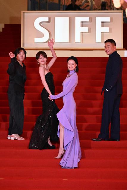 Taiwanese actress Vicky Chen (2L) and Chinese actress Ni Hongjie (2R) arrive on the red carpet of the 28th Shanghai International Film Festival (SIFF) in Shanghai, on June 13, 2026. (Photo by Jade Gao / AFP)