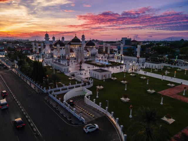 This aerial picture shows Baiturrahman Grand Mosque during sunset in Banda Aceh on June 13, 2026. (Photo by CHAIDEER MAHYUDDIN / AFP)