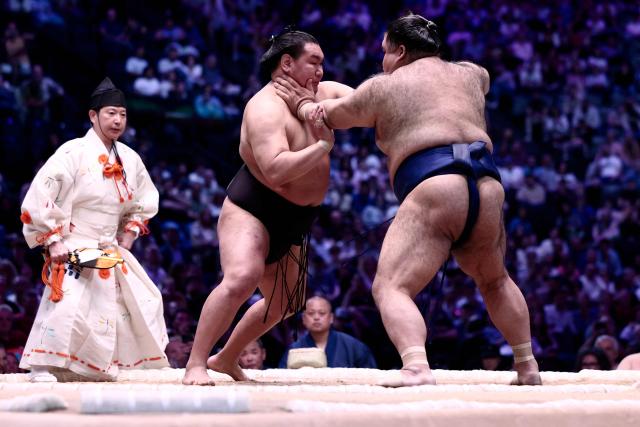 Japanese sumo wrestler Hoshoryu (L) battles Japanese sumo wrestler Takayasu during their bout on day 1 of the 2026 MUFG Paris Sumo Tournament, in Paris on June 13, 2026. (Photo by Behrouz MEHRI / AFP)