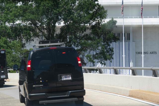 The motorcade of US President Donald Trump drives past a tarp covering the facade of the John F. Kennedy Memorial Center for the Performing Arts in Washington, DC, June 13, 2026. The John F. Kennedy Center for the Performing Arts in the US capital on Saturday said it has removed President Donald Trump's name from its facade following a court ruling. In a legal filing the center's Executive Director Matt Floca said it has "removed all physical signage on the Kennedy Center building and grounds" containing Trump's name. (Photo by SAUL LOEB / AFP)