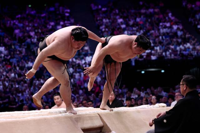 Japanese sumo wrestler Abi (L) battles Japanese sumo wrestler Wakamotoharu during a bout on day 1 of the 2026 MUFG Paris Sumo Tournament, in Paris on June 13, 2026. (Photo by Behrouz MEHRI / AFP)