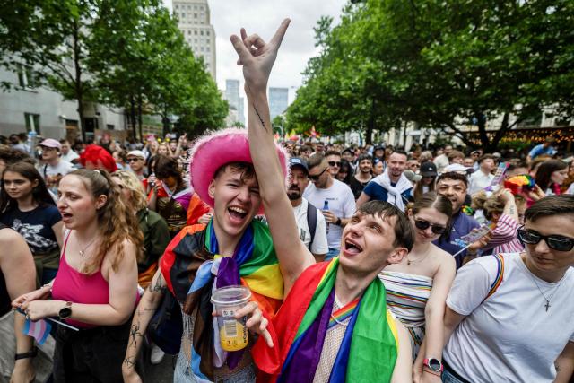 Participants of the Warsaw Pride parade with rainbow-colored flags celebrate in the streets of Warsaw, Poland, on June 13, 2026 (Photo by Wojtek RADWANSKI / AFP)