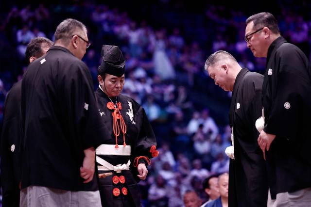 Members of the jury discuss on the sidelines of a bout on day 1 of the 2026 MUFG Paris Sumo Tournament, in Paris on June 13, 2026. (Photo by Behrouz MEHRI / AFP)