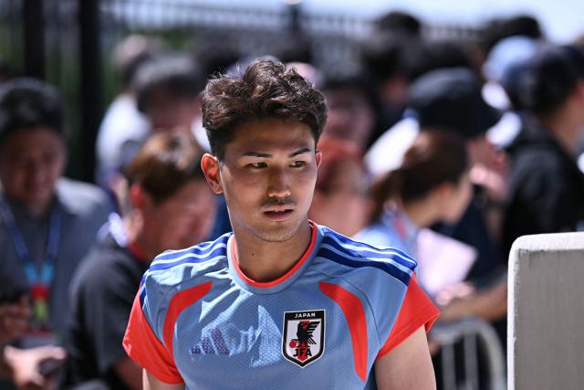Japan's defender #16 Tsuyoshi Watanabe arrives for an MD-1 training session on the eve of the 2026 World Cup Group F football match between the Netherlands and Japan, at the Dallas Stadium in Arlington on June 13, 2026. (Photo by Paul ELLIS / AFP)